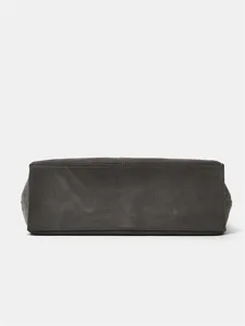 Dark grey tote bag bottom detail, premium leather craftsmanship close-up display.