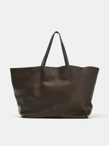 Dark brown leather tote bag detail, spacious minimalist design for daily commute.