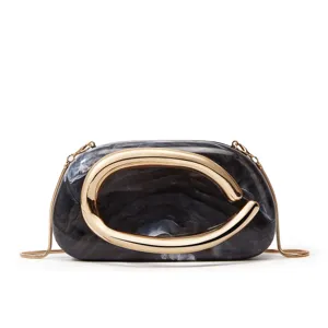 Marble texture acrylic clutch bag with sculptural gold ring decoration and chain strap detail.