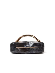 Detailed view of the marble acrylic clutch bag featuring a sleek gold metal top handle.