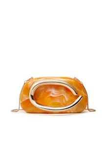 Close-up detail of the orange marbled resin clutch featuring a striking large gold metal C accent.