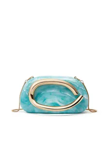 Close-up detail of blue marbled resin clutch bag with gold metal loop handle and chain.