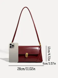 Detailed view of burgundy leather underarm shoulder bag with metal lock and size reference.