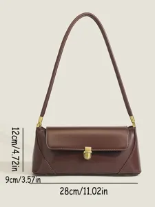 Detail view of the retro brown shoulder underarm bag featuring metallic lock closure and strap.