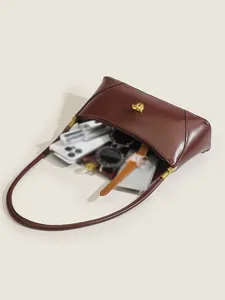 Retro brown leather underarm shoulder bag interior detail displaying large capacity for items.
