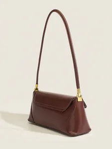 Detailed view of the vintage brown leather underarm shoulder bag with sleek metallic hardware.