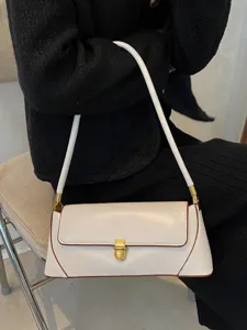 Elegant white leather baguette shoulder bag with chic metal lock and retro style daily use.