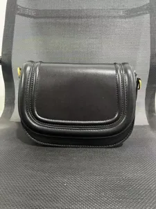Black leather saddle bag with magnetic flap closure and chic stitching for women daily use
