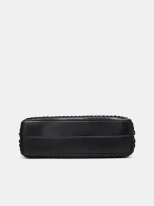 Black woven leather handbag detail, structured bottom base, premium minimalist fashion accessory.