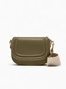 Olive green leather saddle bag with wide canvas strap and chic flap closure for women.