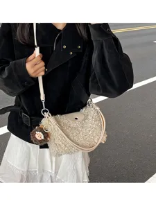 Sherpa crossbody bag detail, featuring fluffy plush texture, elegant handle and cute charm.