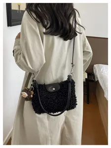 Black lamb fleece crossbody bag for women, stylish winter shoulder handbag with plush texture.