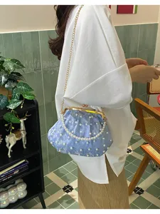 Detailansicht einer hellblauen perlenbestickten Kussverschluss-Muscheltasche mit Goldkette.