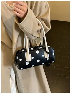 Schwarze und weiße gepunktete zylindrische Bowlingtasche mit weißen Griffen für den Alltag.