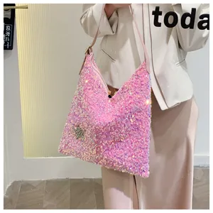 Detailed view of the pink sequin shoulder bag featuring a sparkling star patch and chic style.