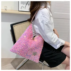 Close-up of the sparkling pink sequin shoulder bag with rhinestone star detail in use.