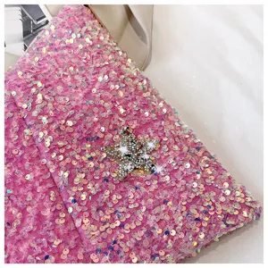 Close-up detail of pink sequin women handbag featuring sparkling crystal star decor stylish.