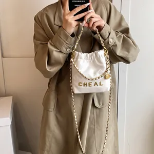 Elegante borsa a secchiello trapuntata bianca con catena da donna, mini borsa a tracolla dorata.
