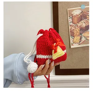 Red crochet Christmas pouch bag with white drawstring and cute bell detail, ideal for kids.