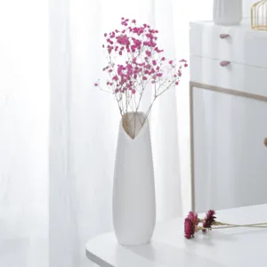 White minimalist ceramic vase with pink dried flowers home decor table centerpiece