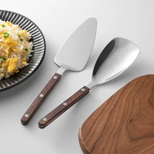 Stainless steel serving utensils with dark wood handles, great for dining and cake serving.