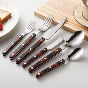 Stainless steel cutlery set with tortoiseshell handles, knife, fork and spoon for home dining use.