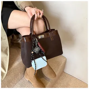 Niche fashion women brown handbag detail showcasing stylish accessories and quality texture.