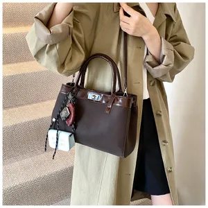 Stylish brown handbag for women, minimalist casual design with patent leather and lock.