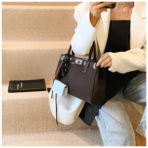 Stylish brown top handle bag for women, chic autumn minimalist crossbody bag with cute charm.
