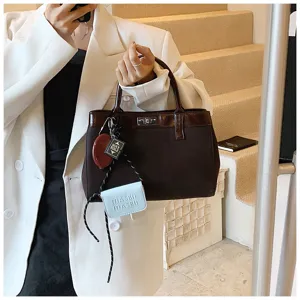 Stylish Maillard brown women handbag with chic charms, casual autumn top-handle bag.