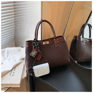 Stylish brown handbag for women, minimalist daily tote bag with charm accessories.