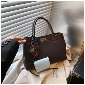 Stylish brown contrast tote bag with mini wallet pendant and chic design for autumn.