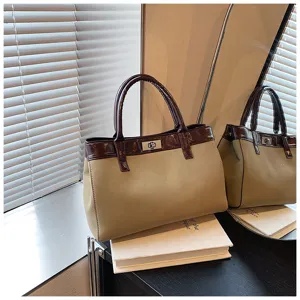 Minimalist Maillard style women handbag, chic brown and beige tote with twist lock closure.