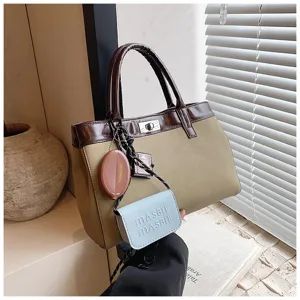 Detail shot of a stylish brown color-block handbag featuring cute hanging charms and top handles.