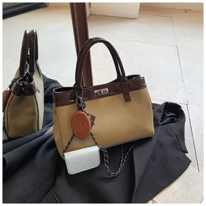 Chic minimalist top handle bag for women, stylish brown and beige faux leather handbag.