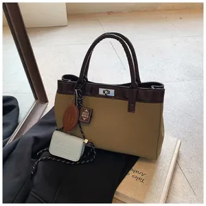 Detailed shot of chic Maillard handbag, contrast color design with cute mini hanging pouch.