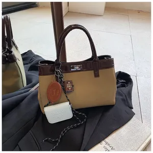 Stylish Maillard top-handle bag with minimalist design, exquisite charms and dual-tone finish.
