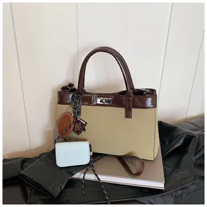 Two-tone stylish handbag with top handle and matching small pouch for daily casual use.