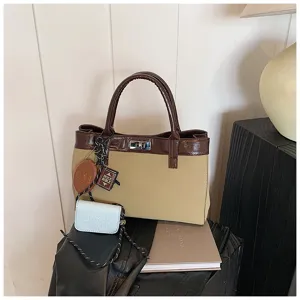 Detailed view of the chic Maillard color block handbag featuring stylish charms and secure metal lock.