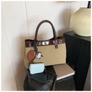 Detail view of the stylish contrast color handbag with mini pouch and charm for women daily look.