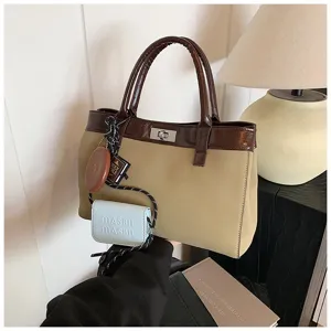 Stylish Maillard contrast color handbag with top handles and chic charm accessories.