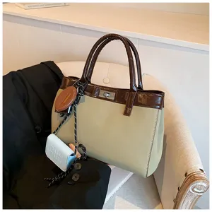 Chic contrast color handbag with top handle and metal lock closure. Stylish design for women.