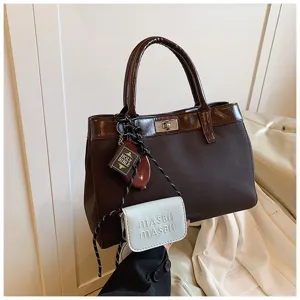Elegant brown canvas handbag with top handle, chic charm and minimalist casual design for autumn.