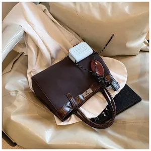 Stylish brown handbag for women, trendy fall Maillard design with top handles and chic accessories.