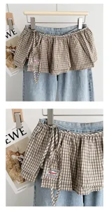 Close-up of the Korean retro plaid layered skirt flounce detail, showing unique tie design.