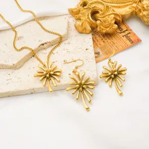 Gold flower pendant necklace and matching earrings set detail shot, stainless steel jewelry.