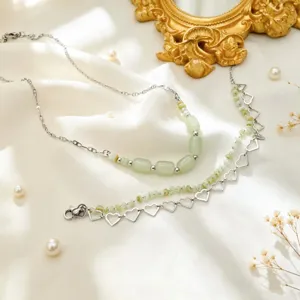 Exquisite light green beaded clavicle chain and hollow heart bracelet jewelry detail view.