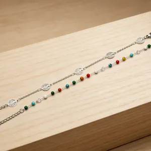 Close-up detail of bohemian style colorful beaded and silver metal chain bracelet design.