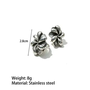 Detailed view of vintage silver flower stainless steel earrings showing texture and size.