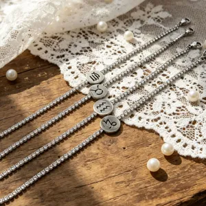 Close-up detail view of dazzling rhinestone tennis bracelets featuring engraved zodiac pendants.